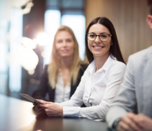 Young businesswoman holding tablet in conference room