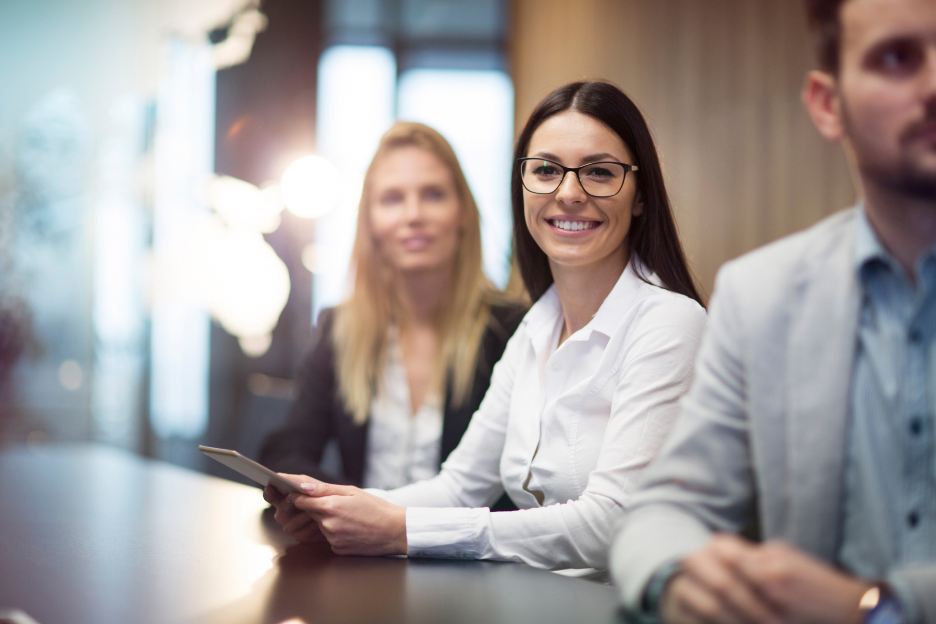 Young businesswoman holding tablet in conference room